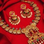 Gold Plated Green And Magenta Pink Stone Studded And Pearl Beaded Temple Jewellery Set